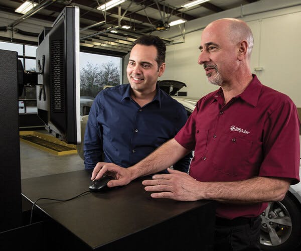 Jiffy Lube employee showing customer information on screen