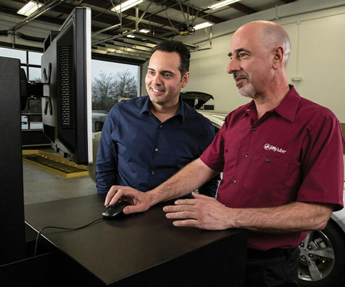 Jiffy Lube employee showing customer information on screen
