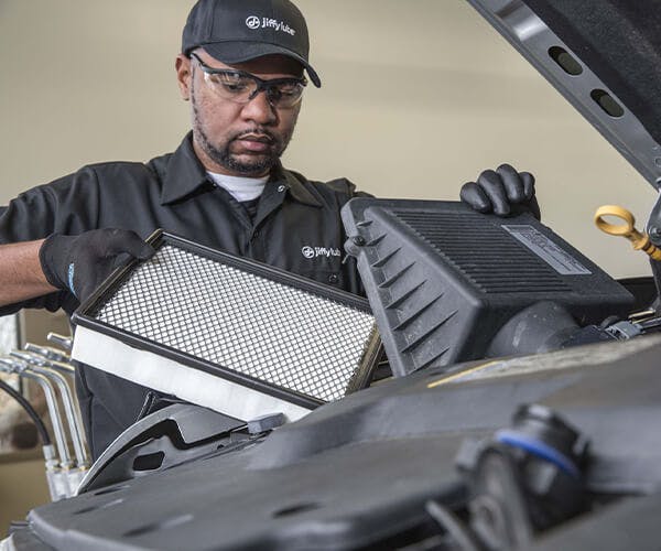 Jiffy Lube employee changing a vehicle filter