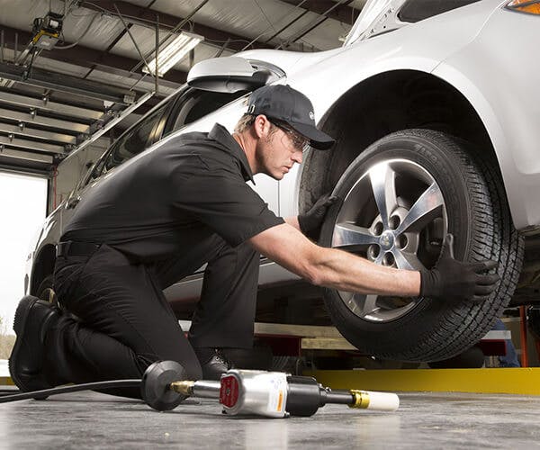 Jiffy Lube employee changing a tier