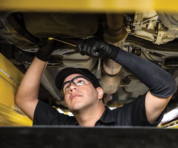 Jiffy Lube employee working underneath a vehicle