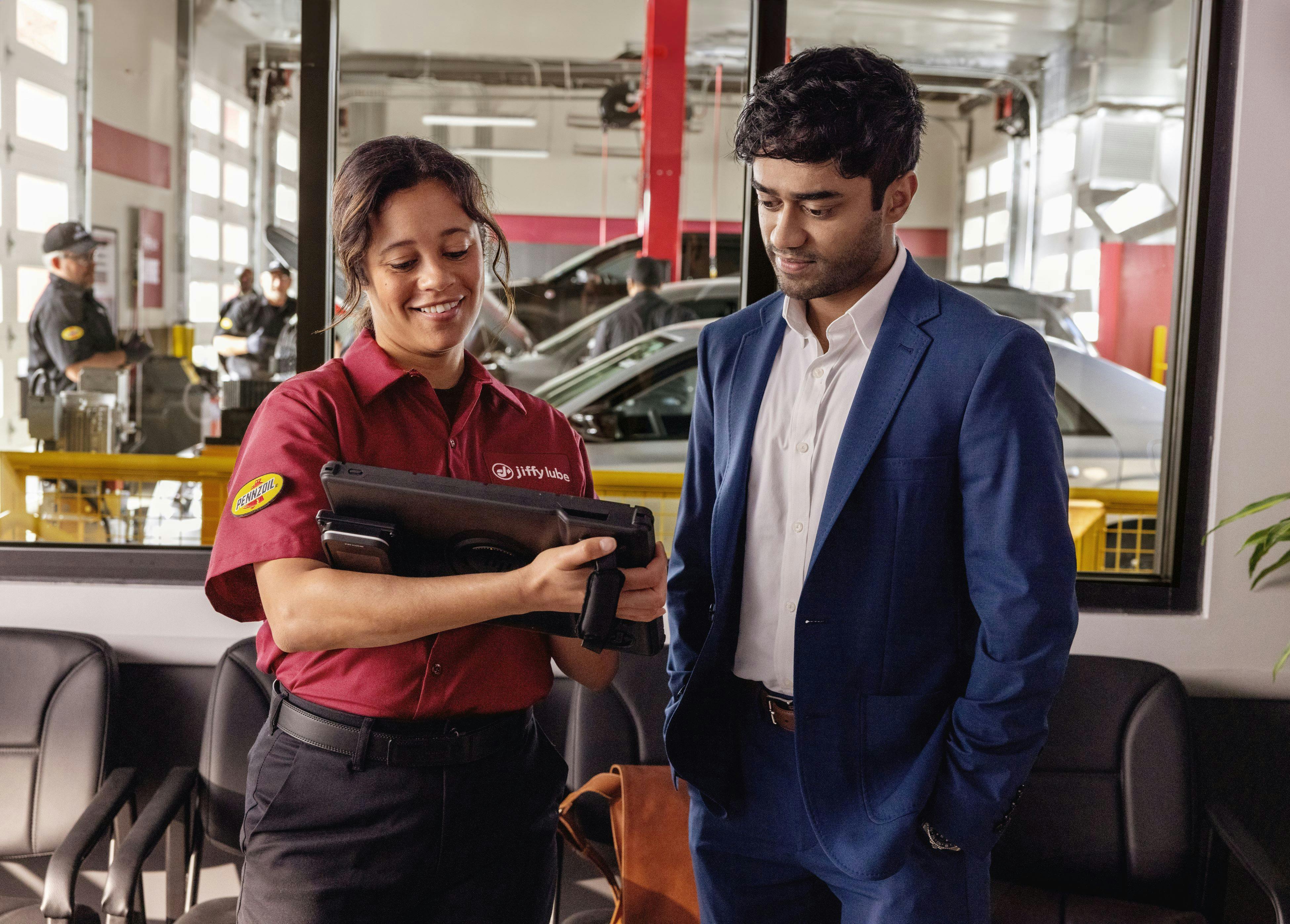 Jiffy lube employee conversing with customer in the lounge