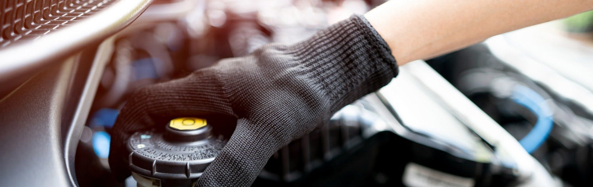 A Jiffy Lube technician performing a brake fluid exchange