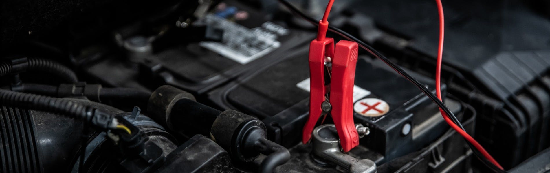 jumper cable on car battery in order to charge it
