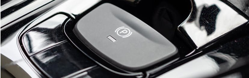 A parking break button in a more modern car 