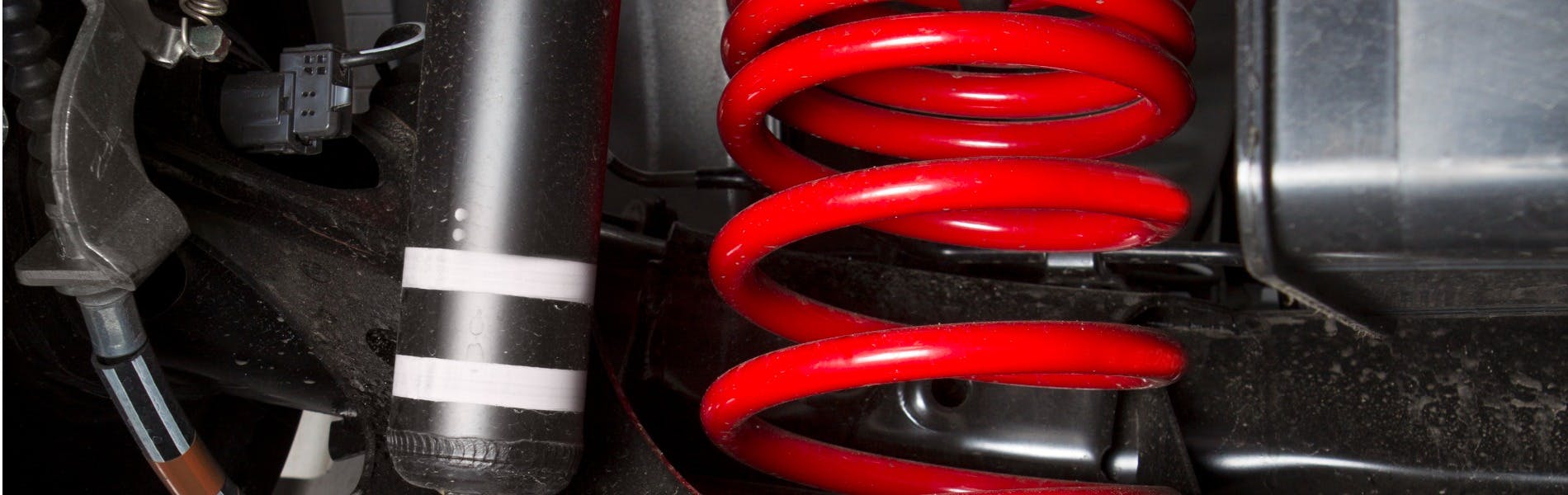 shock spring under a car tire
