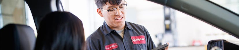 Jiffy Lube employee checking customer in for a fuel filter replacement service