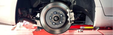 Close up of a car's brake disc during a brake pad replacement 