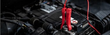 jumper cable on car battery in order to charge it