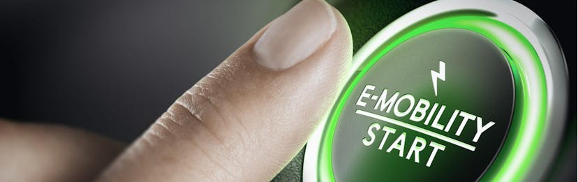 finger pressing the start button of electric vehicle