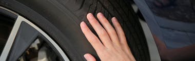 Female hands on tire