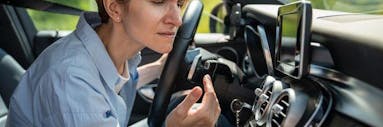 Woman smelling air for car air vent
