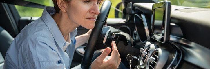 Woman smelling air for car air vent