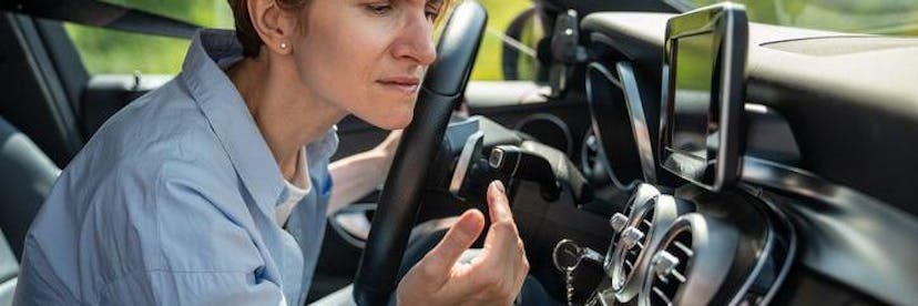 Woman smelling air for car air vent