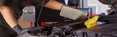 A Jiffy Lube Technician changing a vehicle's oil