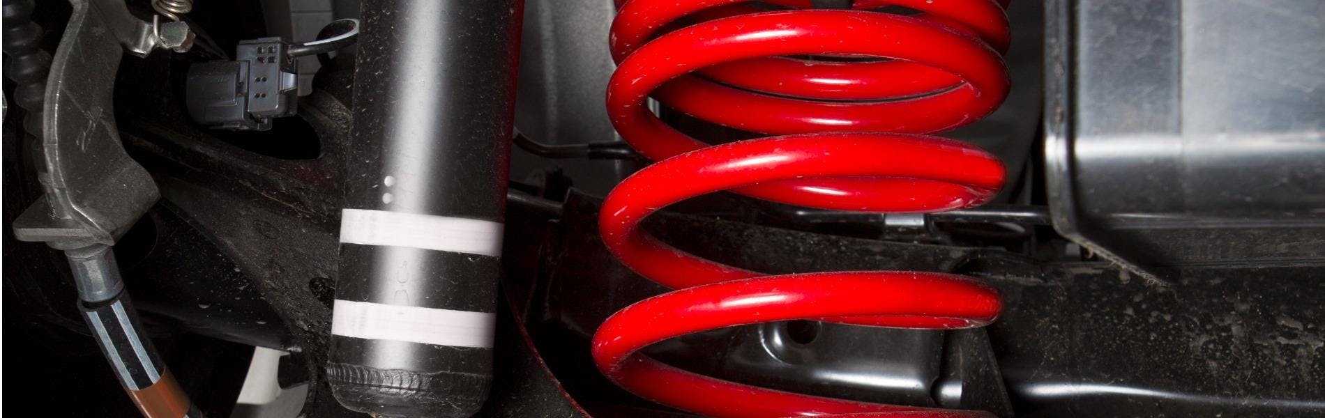 shock spring under a car tire