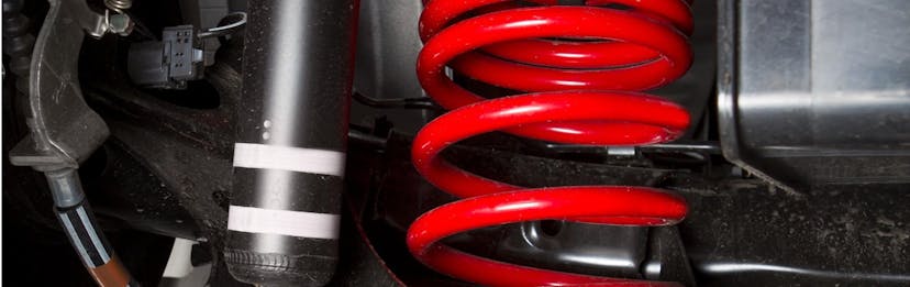 shock spring under a car tire